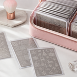 Clean nail stamping plates organised in protective sleeves and a storage case