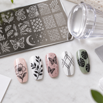 Five nail stamping test swatches beside a plate, clear stamper, scraper, and simple test notes