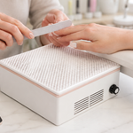 BIUTEE nail dust collector positioned beneath a manicure hand rest in a clean home nail workspace