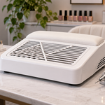White tabletop nail dust collector arranged on a clean manicure workstation